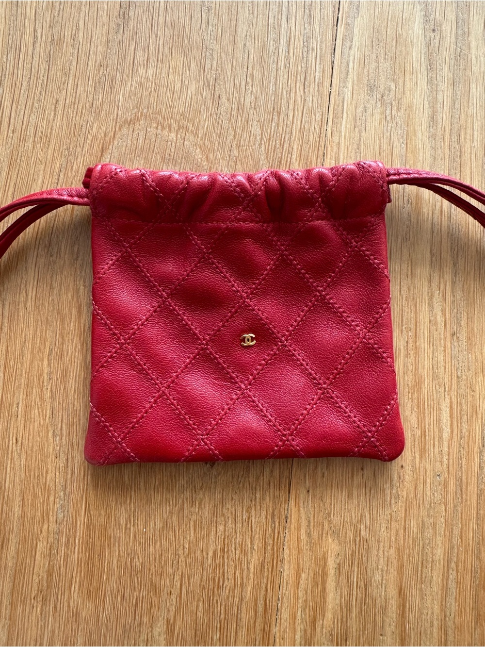 CHANEL Red Quilted Lambskin Drawstring Pouch with Gold CC